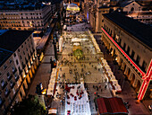 Aerial view of Christmas decoration and entertainment illuminated at night in El Pilar Square, Zaragoza, Spain