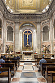 Worshippers in the Chapel of the Blessed Sacrament in the Basilica of St. Paul Outside the Walls, Rome, Italy.