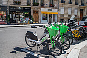 A fleet of about sixty Velib shared bicycles, are lined up neatly at a docking station in Paris, France