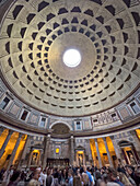 Tourists inside the Pantheon with a wide-angle view showing the oculus in the rotunda. Rome, Italy.