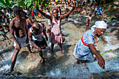 Haiti Voodoo Festival in Saut d'Eau, in Saut d'Eau, Ville Bonheur, Haiti. Thousands of both Vodou and Catholic followers gathered under the Saut d'Eau waterfall in Haiti. The pilgrimage, made by Voodou practitioners and Catholics alike, originated with the sighting of the likeness of the Virgin Mary on a palm leaf close to the falls half a century ago. Catholism and Voodou practices are forever intertwined in its Haitian form. The appearance of a rainbow beneath the falls is said indicate that Danbala - the great lord of the waterfall - and Ayida Wedo - the rainbow - are making love. Fertility