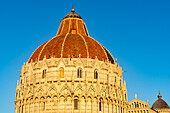 Baptistery of St. John of the Pisa Cathedral in the Piazza dei Miracoli in Pisa, Italy. The top half of the baptistery is Gothic style, while the lower half is Romanesque.