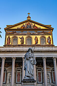 The statue of St. Paul and facade of the Basilica of St. Paul Outside the Walls, Rome, Italy.