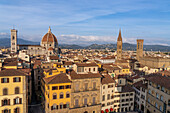 View of the Duomo or Cathedral of Santa Maria del Fiore from the Palazzo Vecchio tower in Florence, Italy. At right are the towers of the Badia Fiorentina and Palazzo del Bargello.