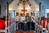 Inuit choir in traditional dresses, inuit music, Aappilattoq church village, South Greenland, Arctic sea.