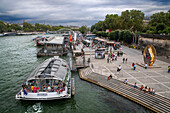 Passenger touristic cruise ship in the Seine river is moored to the pier near Eiffel Tower