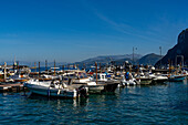 Small boats docked in the harbor of Marina Grande on the island of Capri, Italy. The Sorrento Peninsula is behind.