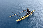 Residents of Tungelo Island in their traditional dugout canoes, New Ireland province, Papua New Guinea