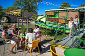 Canal du Midi at bridge and village of Le Somail Aude South of France southern waterway waterways holidaymakers queue for a boat trip on the river, France, Europe