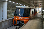 A Skylink light rail train comes into a terminal station at Dallas Fort Worth International Airport. Dallas, Texas.