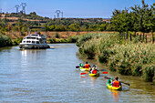 Kayaking in the canal du midi a Trèbes, France. Boat in the Canal du Midi near Carcassonne Aude South of France southern waterway waterways holidaymakers queue for a boat trip on the river, France, Europe