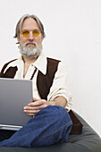 Porträt eines Mannes, der einen Laptop-Computer hält