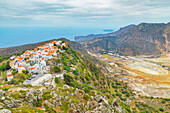 Nikia village and Nisyros volcano in the distance, high anlgle view, Nisyros Island, Dodecanese Islands, Greek Islands, Greece, Europe