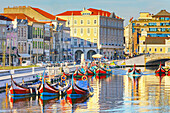 View of moliceiro boats floating on Aveiro river main lagoon, Aveiro, Portugal, Europe