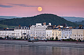 Strawberry Moon rising over Llandudno Seafront, Llandudno, Conwy County Borough, North Wales, United Kingdom, Europe