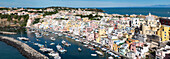 Panoramic view of town, colourful houses and sea, Corricella, Procida island, Phlegraean Islands, Bay of Naples, Campania, Italy