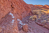 Patches of snow in the shade of a hill in Dead Wash at Petrified Forest National Park, Arizona, United States of America