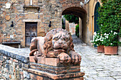 A stone lion guarding the traditional village of Lucignano d'Asso, comune of Montalcino, Tuscany, Italy