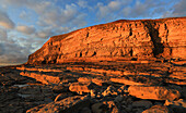 Golden evening light on the limestone cliffs, Dunraven Bay, Southerndown, Vale of Glamorgan, Wales, United Kingdom