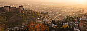 Autumnal panorama of The Alhambra, UNESCO, with warm sunset over the Albaicin, Granada, Andalucia, Spain