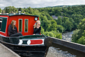 Narrow boat on Pontcysyllte Aqueduct, UNESCO, Llangollen Canal over valley of the River Dee, Wales, United Kingdom