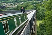 Narrow boat on Pontcysyllte Aqueduct, UNESCO, Llangollen Canal over valley of the River Dee, Wales, United Kingdom