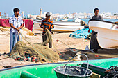 Fishermen on the beach in front of the Al Ayjah village, Sur, port-city, capital of Ash Sharqiyah Region, Sultanate of Oman, Arabian Peninsula