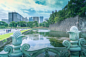 View of city skyline reflecting in the moat of the Imperial Palace of Tokyo, Tokyo, Honshu, Japan