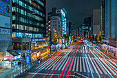 View of city street and trail lights at night, Minato City, Tokyo, Honshu, Japan