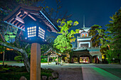 View of Oyama Shrine Shinmon Gate illuminated at dusk, Kanazawa City, Ishikawa Prefecture, Honshu, Japan