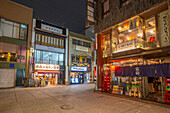 View of street scene and Japanese restaurants in Hiroshima at night, Hiroshima, Honshu, Japan