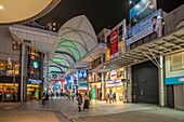 View of colourful shops and restaurants in shopping arcade at night, Hiroshima, Honshu, Japan