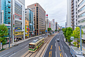 Elevated view of traffic and tram on major street during daytime, Hondori, Naka Ward, Hiroshima, Honshu, Japan