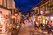 View of shops and narrow street in Sannen Zaka in Gion at dusk, Kyoto Geisha District, Kyoto, Honshu, Japan