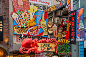 View of colourful facades of restaurants in Dotonbori, vibrant entertainment district near the river, Osaka, Honshu, Japan