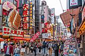 View of colourful signs of restaurants in Dotonbori, vibrant entertainment district near the river, Osaka, Honshu, Japan