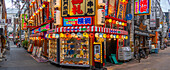 View of colourful facades of shops and restaurants in Dotonbori, vibrant entertainment district near the river, Osaka, Honshu, Japan