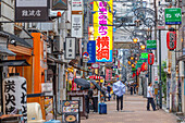 View of colourful signs in backstreet in Dotonbori, vibrant entertainment district near the river, Osaka, Honshu, Japan