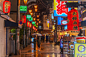 View of colourful signs in backstreet in Dotonbori, vibrant entertainment district near the river, Osaka, Honshu, Japan