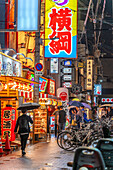 View of colourful signs in backstreet in Dotonbori, vibrant entertainment district near the river, Osaka, Honshu, Japan