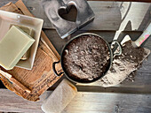 Ingredients for traditional ash soap arranged on a wooden table