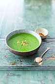 Cream of broccoli and spinach soup with pine nuts and ashwagandha powder