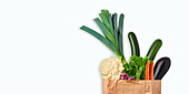 Cut-out of a paper carrier bag with fresh vegetables: leek, cauliflower, courgette, carrots