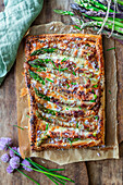 Puff pastry tart with green asparagus wrapped in bacon