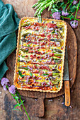 Tart with green asparagus wrapped in bacon