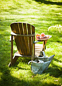 Peaches in a bowl on the back of a garden chair