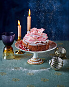 Festive cake with sugar flower, redcurrants and icing sugar