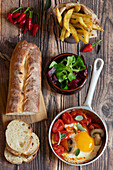 Fried egg with tomatoes, mushrooms, side salad and French fries