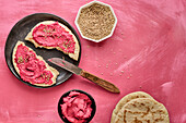Pita bread with beetroot spread and sesame seeds
