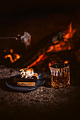 S'mores with roasted marshmallows, chocolate and whisky drink